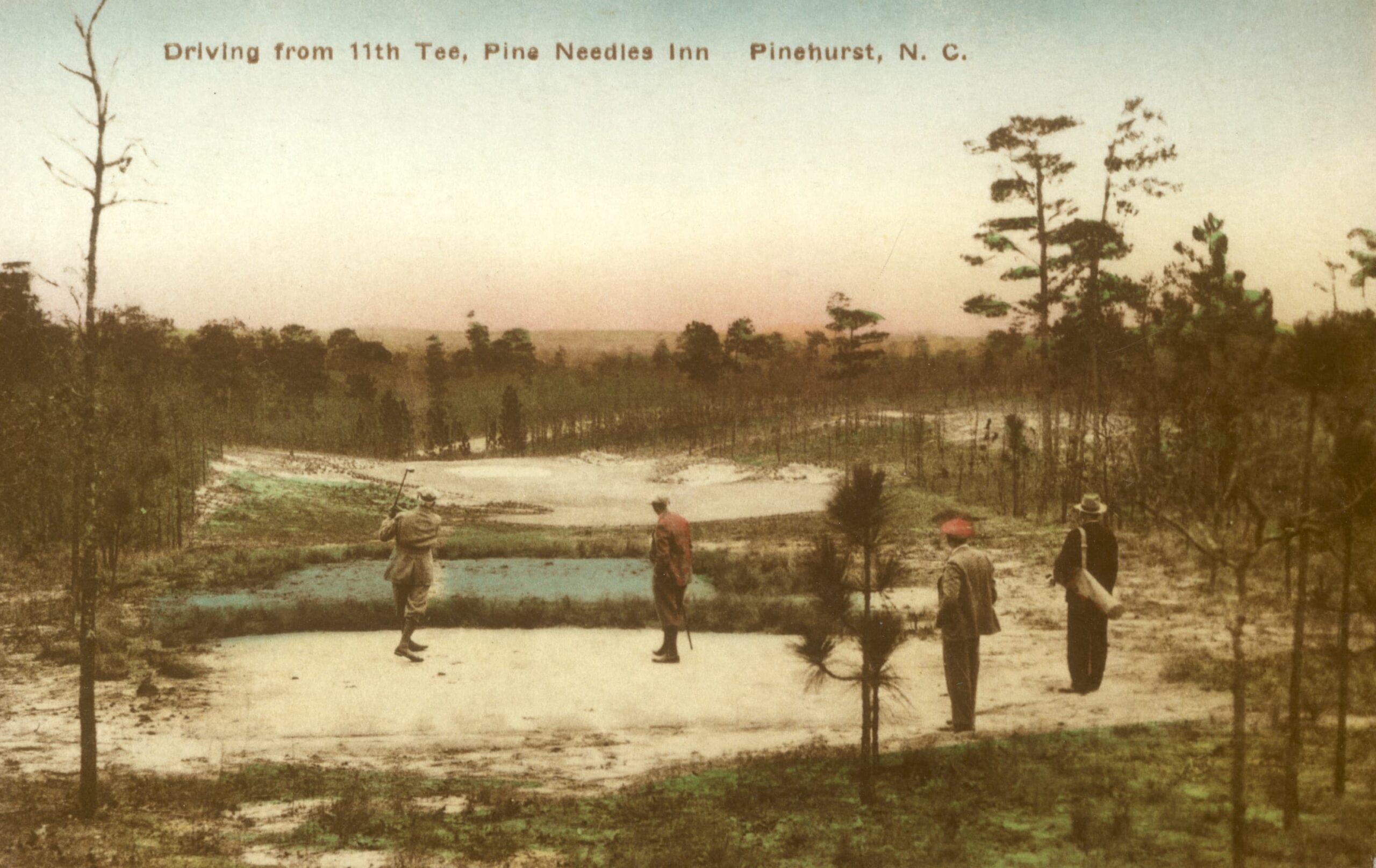 A vintage image showing four men on a golf course near Pinehurst, North Carolina. One man is preparing to drive from the 11th tee, while the others watch from the right. The landscape features trees and a putting green in the background.